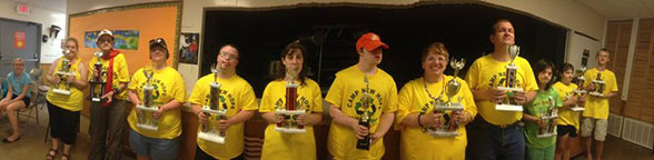 Summer campers holding trophies